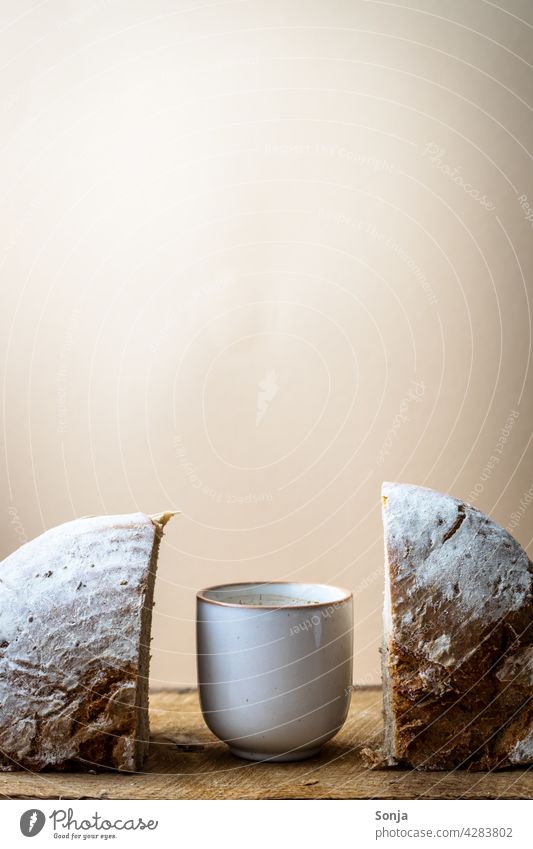 Two halves of bread and a cup of coffee in the middle on a wooden table Bread Coffee cup Breakfast Morning Rustic Coffee break Old Brown Hot Beverage Espresso