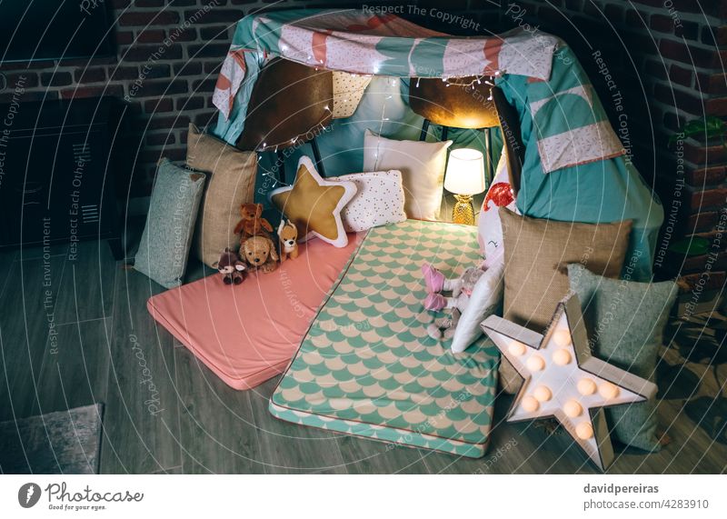 Diy tent decorated for pajama party diy teepee makeshift home nobody empty homely decoration chairs bed sheets cushion cute play mats garland of lights