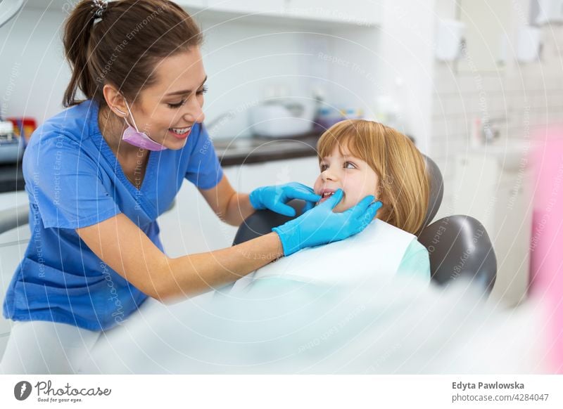 Child at the dentist dentistry attractive adults young adult general practitioner gp female woman people physician professional staff doctor healthcare medicine