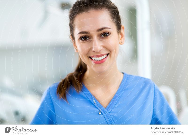 Female dental assistant in office dentist dentistry attractive adults young adult general practitioner gp female woman people physician professional staff