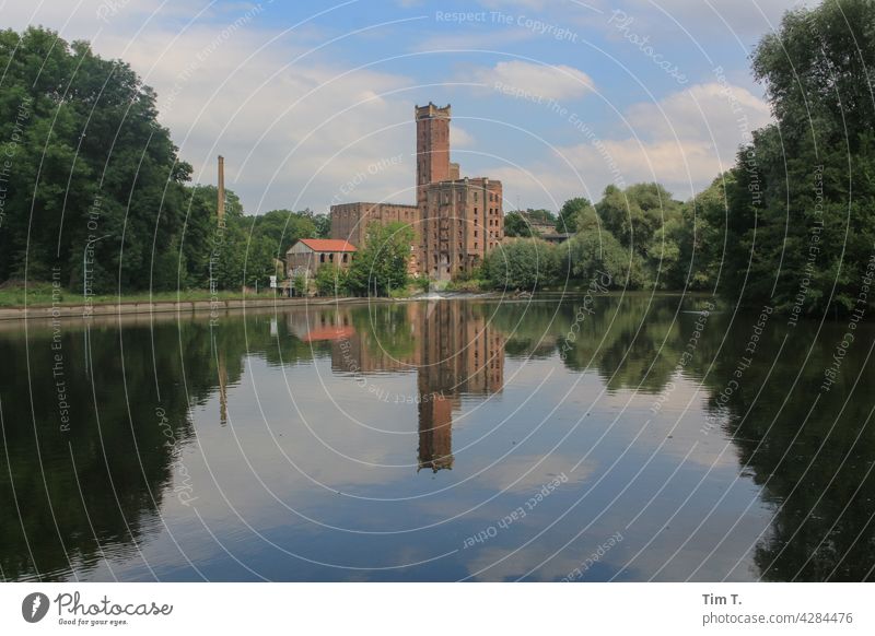 the old paper mill on the Saale is reflected in the Saale river Paper mill Halle (Saale) building Deserted Colour photo Hall Saale Exterior shot Germany