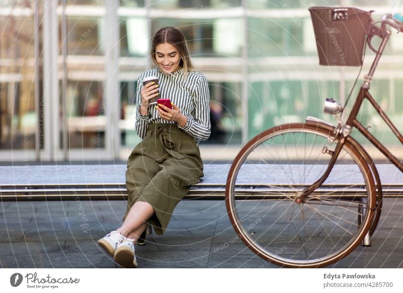 Young woman with her bicycle in the city holiday vacation fashion enjoying lifestyle young adult people casual caucasian positive happy smiling female