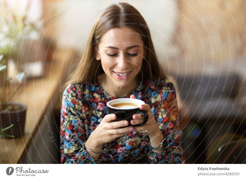 Young woman with cup of coffee people young adult casual attractive female smiling happy Caucasian toothy enjoying one person beautiful portrait positivity