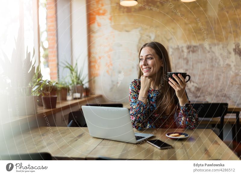 Woman with laptop in cafe people woman young adult casual attractive female smiling happy Caucasian toothy enjoying one person beautiful portrait positivity