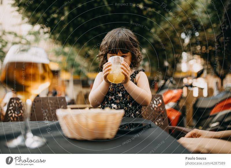 Child drinking Juice Girl Caucasian 1 - 3 years Summer Refreshment Colour photo Human being Infancy Exterior shot Lifestyle Cute Day Glass Park Joy Happiness