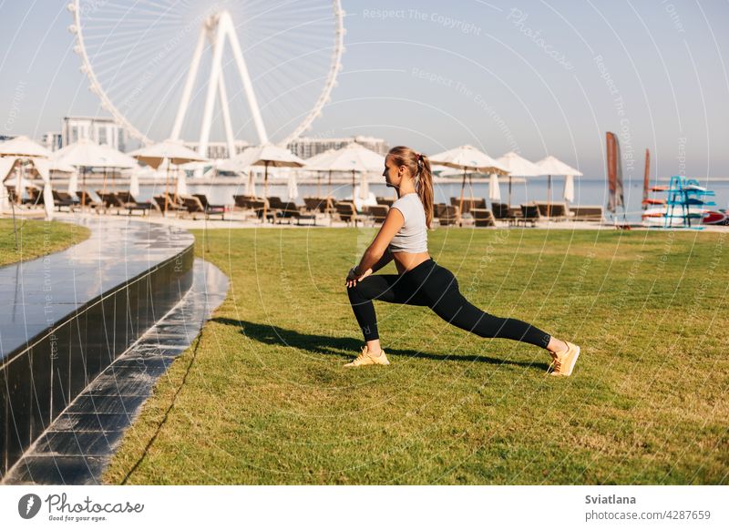 A beautiful woman does yoga on the background of the Blue Waters Island in Dubai. Sports, fitness, healthy lifestyle. Space for text dubai body girl female