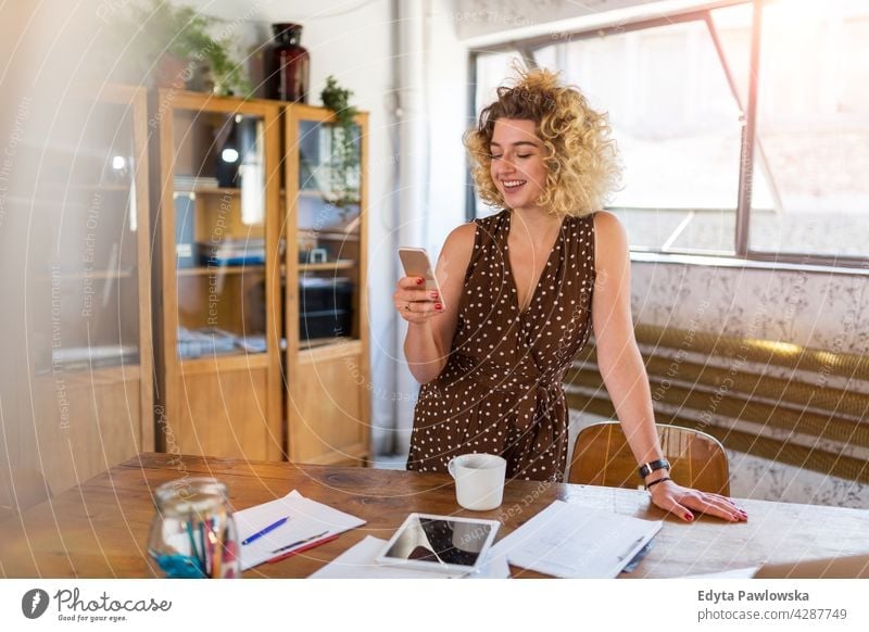 Shot of a young female designer working in her office business businesspeople businessperson businesswoman caucasian indoors informal casual young adult