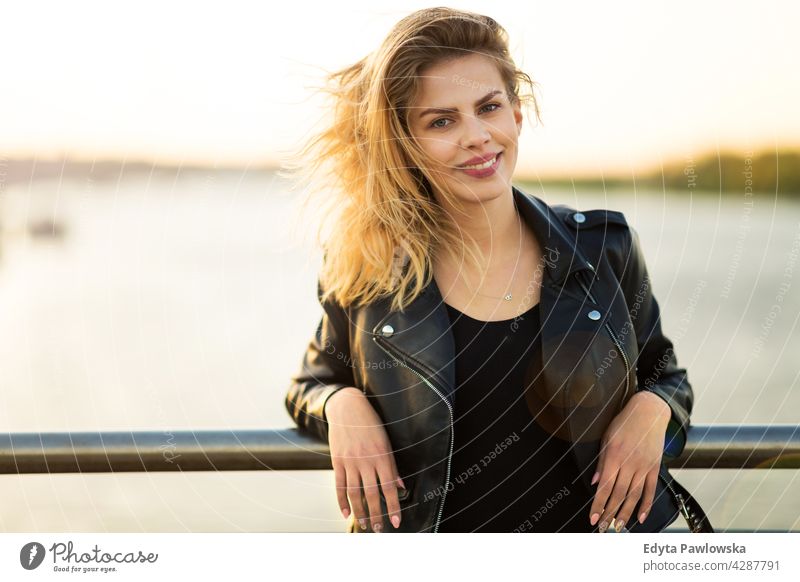 Young woman in the city at sunset enjoying lifestyle young adult people casual caucasian positive happy smiling female attractive beautiful day outdoors urban