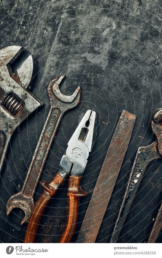Old hardware tools. Wrench, screwdriver, measure, hammer, pliers on steel surface. Mechanic tools for maintenance. Hardware tools to fix. Technical background