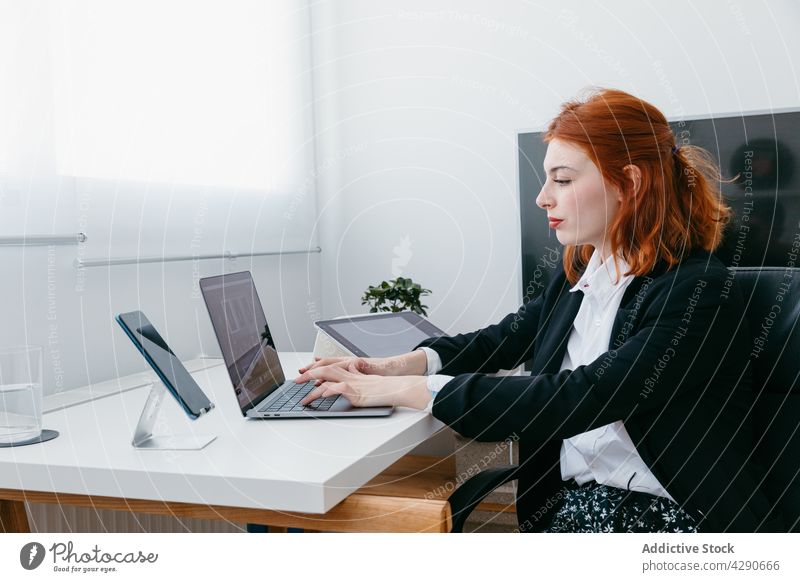 Businesswoman typing on laptop at table in house businesswoman startup project black screen work independent home using gadget device smartphone netbook