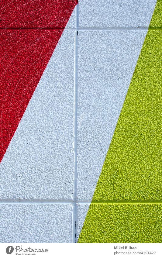 wall of red white and yellow colors on a building exterior colours texture textured paint colourful background brush structure stripe stripes colorful