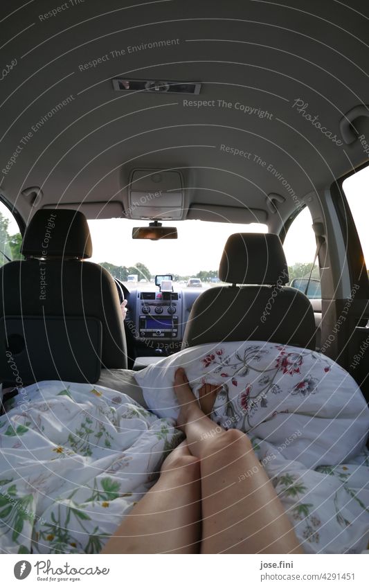 Bed in back luggage | legs on a mattress in the trunk of a car Trip Woman Friends Highway travel Weekend Mattress Duvet Trunk Cozy sunny Summer vacation Simple