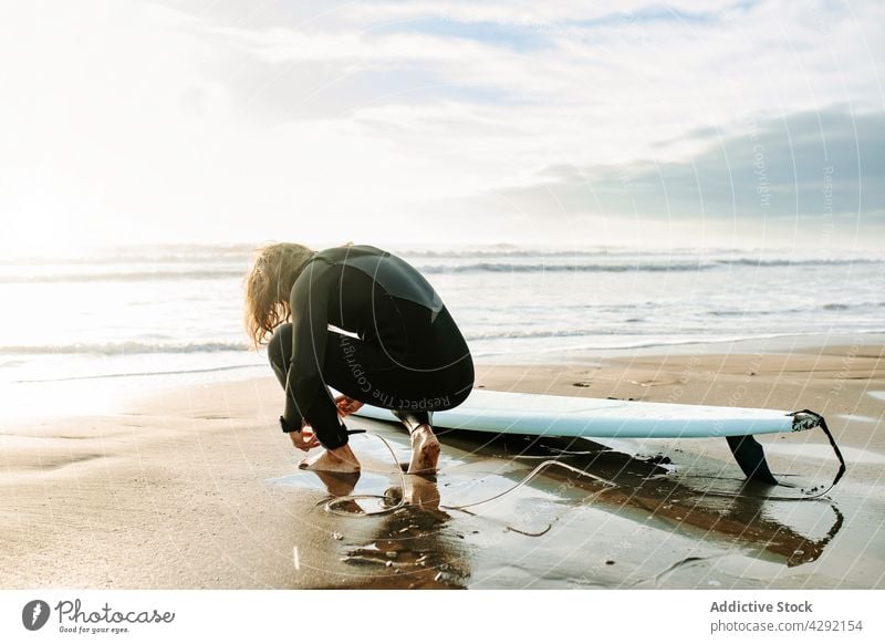 Surfer at the beach with surfboard man nature sunset wave outdoors wetsuit seacoast male sportsman surfing hobby long hair surfer ocean get ready seaside calm