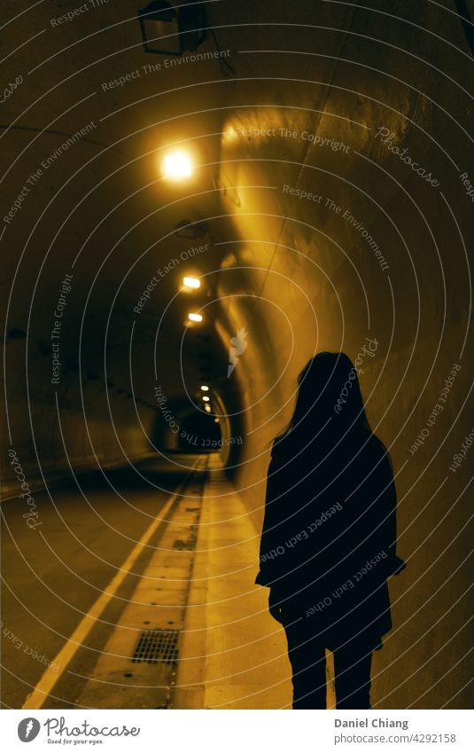 Girl's Back In The Night Tunnel Dark Mysterious lonely Exterior shot Night shot one person road Design darkness Uniqueness Man contrasts Interior shot Light