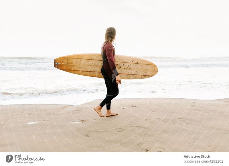 Anonymous surfer at the beach with surfboard man nature walking sunset wave outdoors wetsuit seacoast male sportsman surfing hobby ocean seaside calm catch