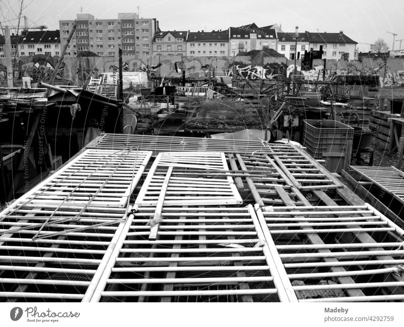 Allotment gardens with bulky waste and improvised greenhouses in the harbour garden at the old inland harbour in Offenbach am Main in Hesse, photographed in classic black and white