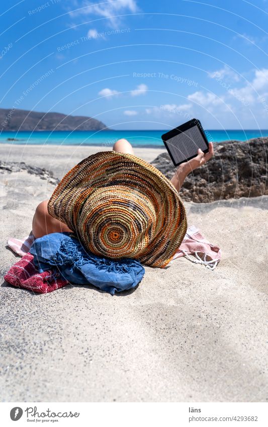 Reading on the beach Woman Beach Vacation & Travel ebook reader Relaxation Book Hat Lie Human being Exterior shot 1 Adults Colour photo coast Ocean