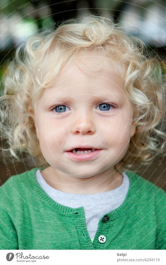 Little baby boy with curl hair and blue eyes - a Royalty Free Stock Photo  from Photocase