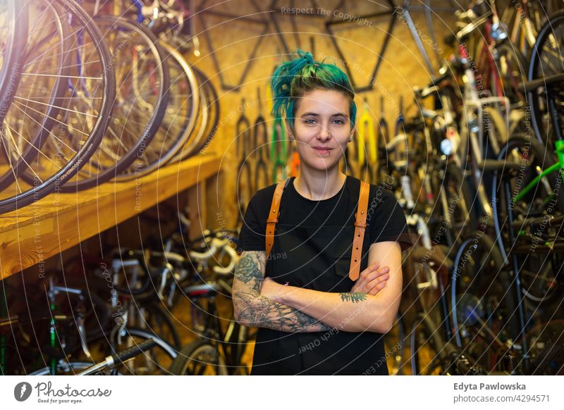 Saleswoman in bicycle shop sales clerk bicycle mechanic bicycling bike shop business retail helpful indoors female manager owner profession repair repair shop