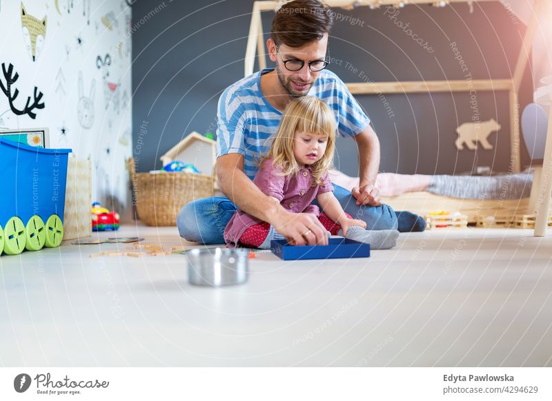 Father Playing with Daughter At Home home house man dad father family parent relatives child daughter girl little girl kid kids children relationship together