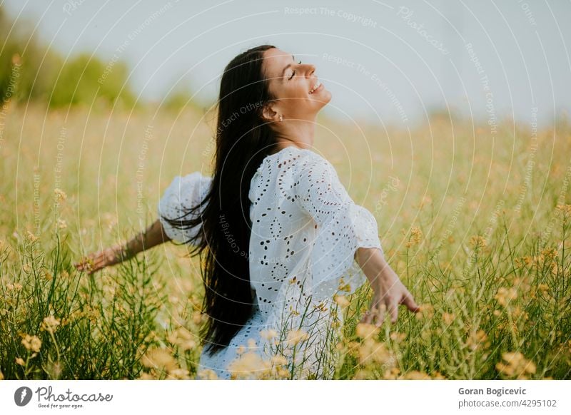 Young woman in the rapeseed field beautiful outside yellow summer outdoor beauty happy spring person meadow nature flower freedom female lifestyle sunny floral
