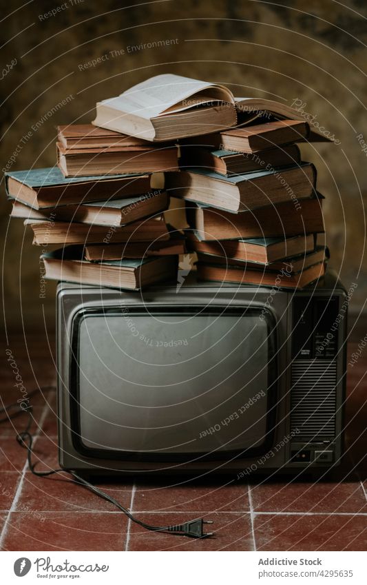 Stack of books on retro TV tv stack floor shabby composition concept old hobby literature decor weathered vintage interesting story novel volume fiction wisdom