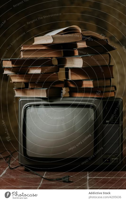 Stack of books on retro TV tv stack floor shabby composition concept old hobby literature decor weathered vintage interesting story novel volume fiction wisdom