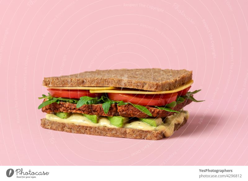 Vegan sandwich close-up isolated on a pink background. alternative arugula avocado awareness bread breakfast burger cheese clean color consumerism copy space