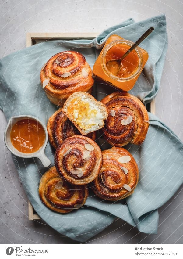 Cinnamon buns with jam and honey breakfast morning serve sweet dessert food tray fabric pastry heap homemade baked cinnamon meal tasty fresh delicious