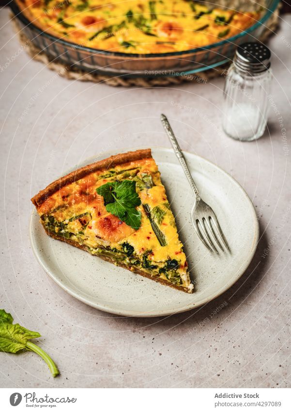 Delicious quiche placed near ingredients tart dish food fresh nutrition cuisine vegetable french tradition parsley slice authentic organic herb culinary