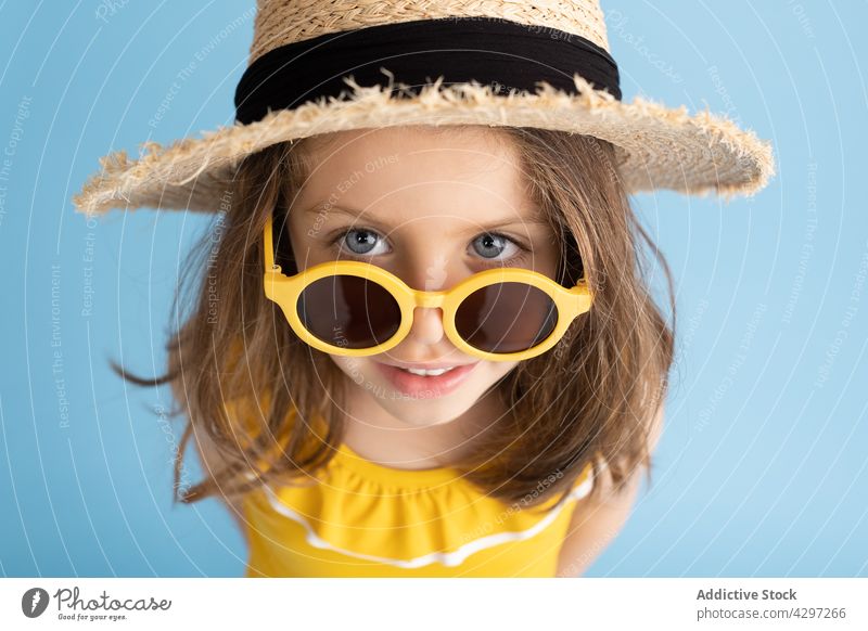 Stylish little girl in summer outfit style yellow fashion happy smile kid sunglasses beach child cute bright cheerful trendy carefree straw hat color cool