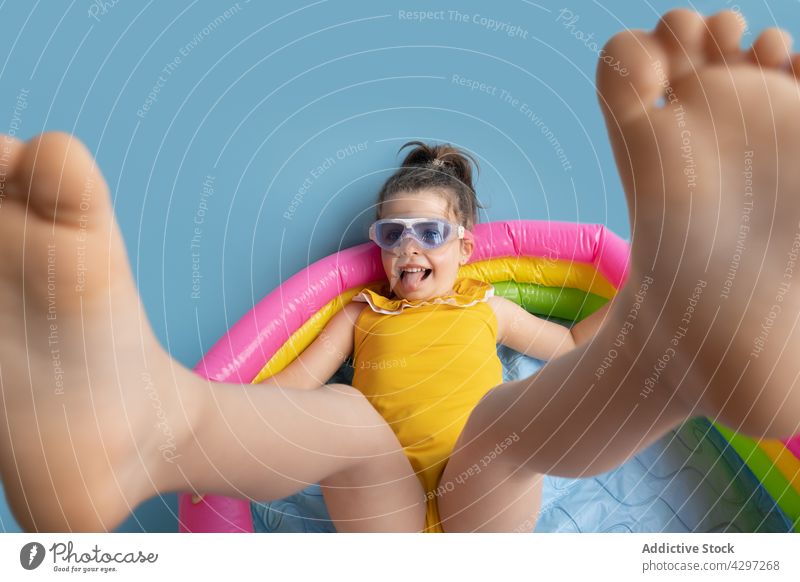 Happy kid floating in inflatable mattress in pool girl summer swim color enjoy happy child rest water pretend ring relax bright childhood colorful vacation