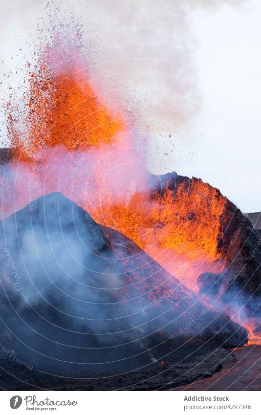 Volcano bursting with hot lava volcano mountain nature geology smoke catastrophe energy iceland volcanic peak burn molten rock heat fume steam formation rough