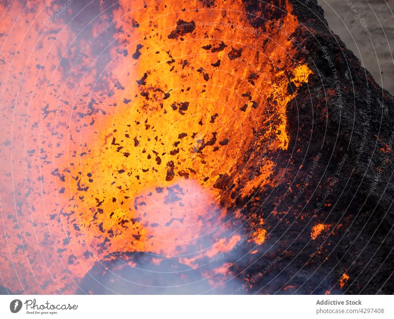 Volcano bursting with hot lava volcano mountain nature geology smoke catastrophe energy iceland volcanic peak burn molten rock heat fume steam formation rough