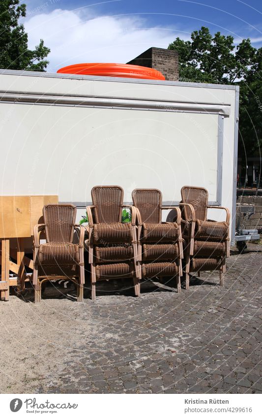stacked chairs stand behind a bar cart wicker chairs beer trolley Terrace Beer garden Gastronomy Roadhouse out beachable Beach bar Sand Closed Summer Wait