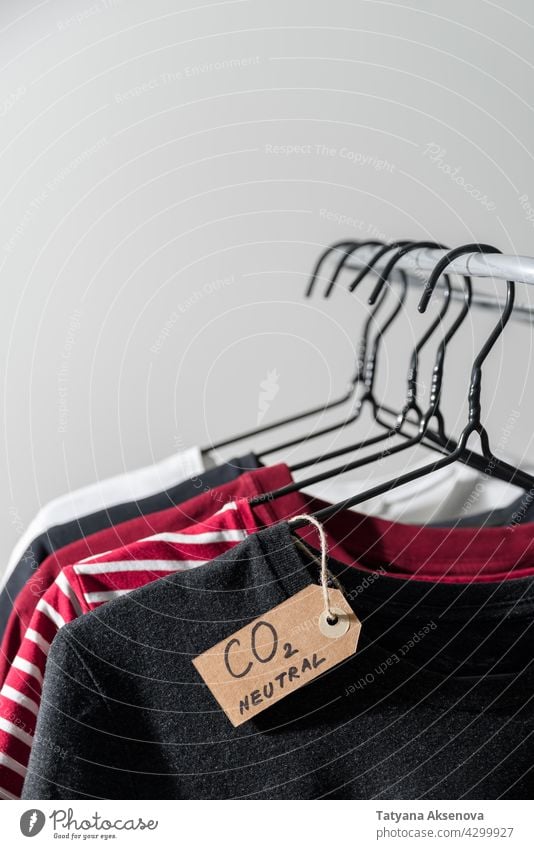Clothes with carbon emission label clothes hanger rail neutral store retail shop rack second hand casual purchase textile wear fabric choice shopping cotton