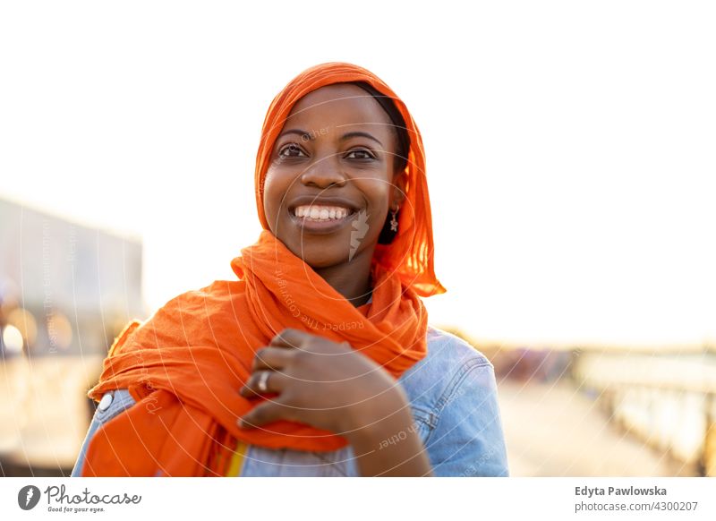Young woman in hijab outdoors at sunset afro proud real people city life African american afro american student Black ethnicity sunny outside pretty girl person