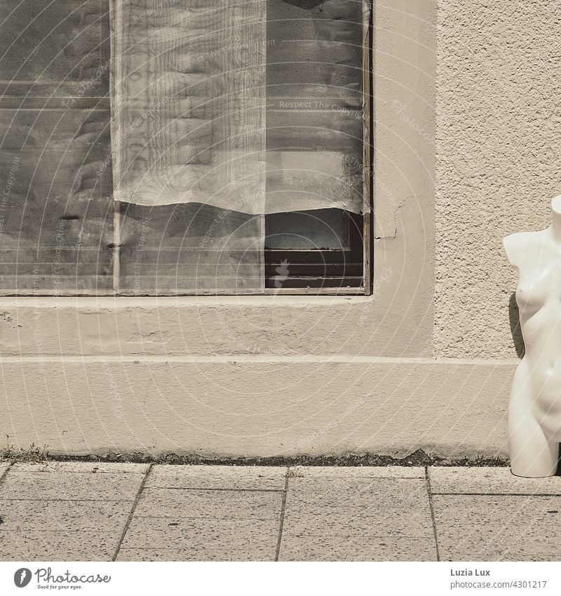 left and naked... Torso of a mannequin stands next to an empty shop window with the curtains down Shop window Street Sidewalk Exterior shot Facade Deserted
