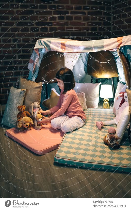 Girl playing with stuffed animals in a teepee lovely girl play mats bed sheets chairs kid childhood female toy joy sweet beautiful little cute people person