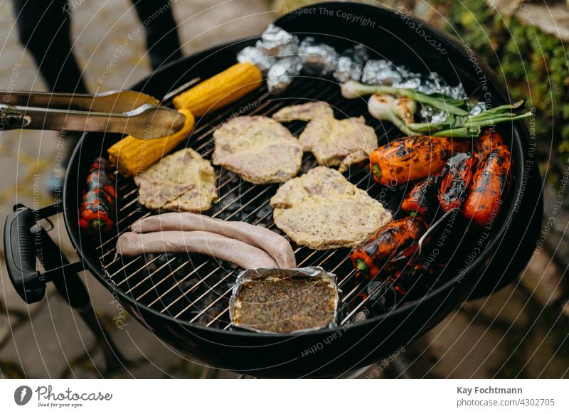 grill with meat and vegetables during barbecue backyard barbecue tongs bell pepper cheese cooking cookout corn corn on the cob day delicious fire food