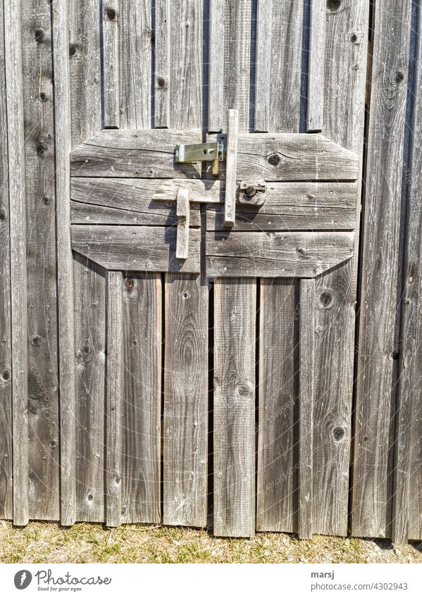 Multiple secured wooden barn door. A riddle with seven seals. Wood Goal safeguarded Locking bar Closed Safety Entrance tricky no escape output lock Loneliness