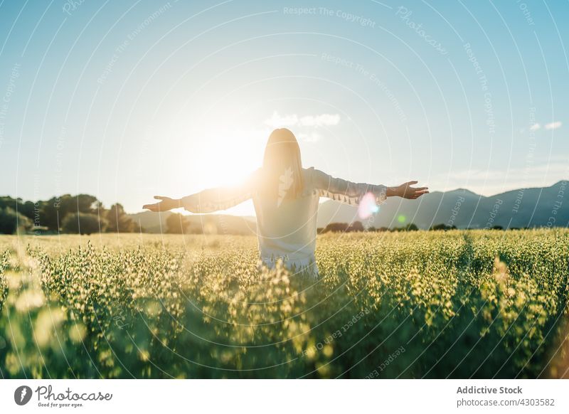 Happy woman showing V sing in countryside field freedom two fingers peace nature v sign happy white dress hippie style flower tranquil calm harmony slim meadow