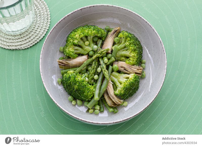 Closeup viewed from above of a vegetable dish with broccoli, mushrooms and peas food vegetarian vegan healthy fresh organic diet collection background icon