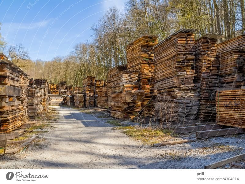 stacked wooden boards lumber timber planks wooden planks pile sunny sawmill lumber mill industrial sliced flitches trimmed drying lumber yard wood drying