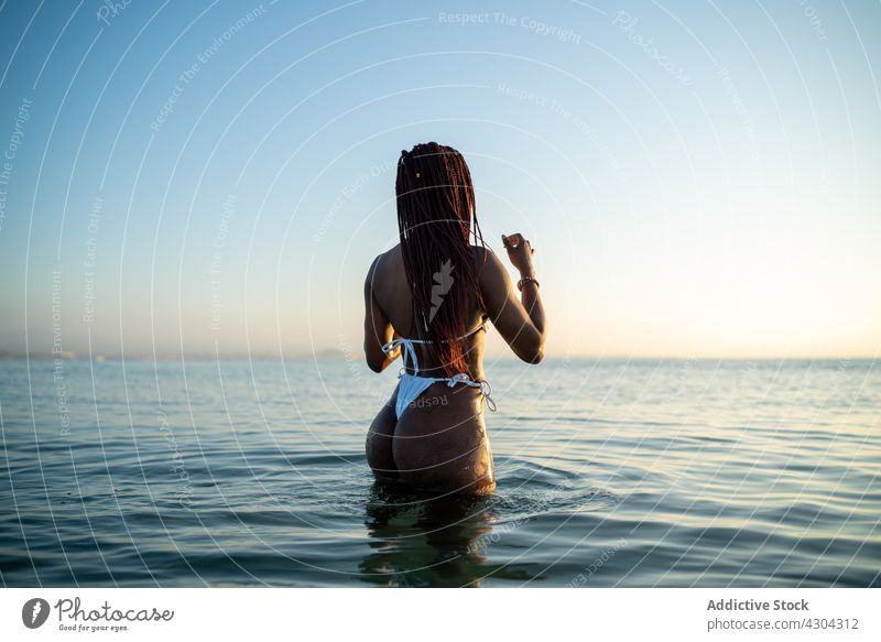 Black woman with braids on the beach bikini summer black african vacation beautiful sea young portrait happy attractive person holiday afro background isolated