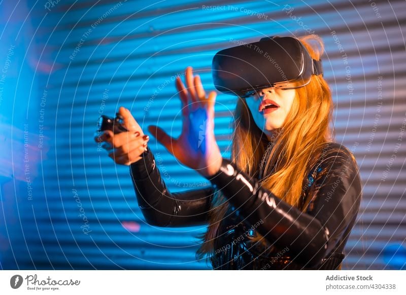 Amazed female exploring virtual reality woman play videogame vr amazed explore gesture controller interact entertain technology device headset gamepad astonish