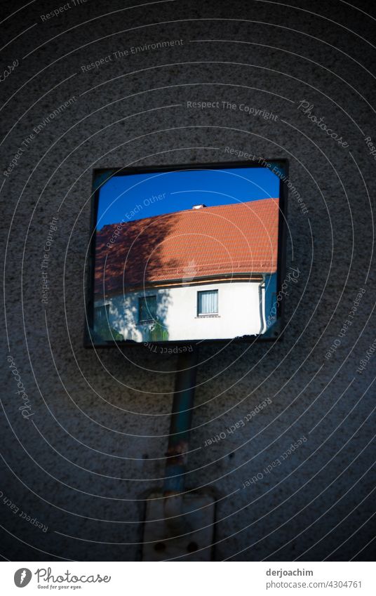 Everything in the mirror view. Blue sky, part of a house with window. Mirror Mirror image look at Reflection Exterior shot Day reflection Colour photo Deserted
