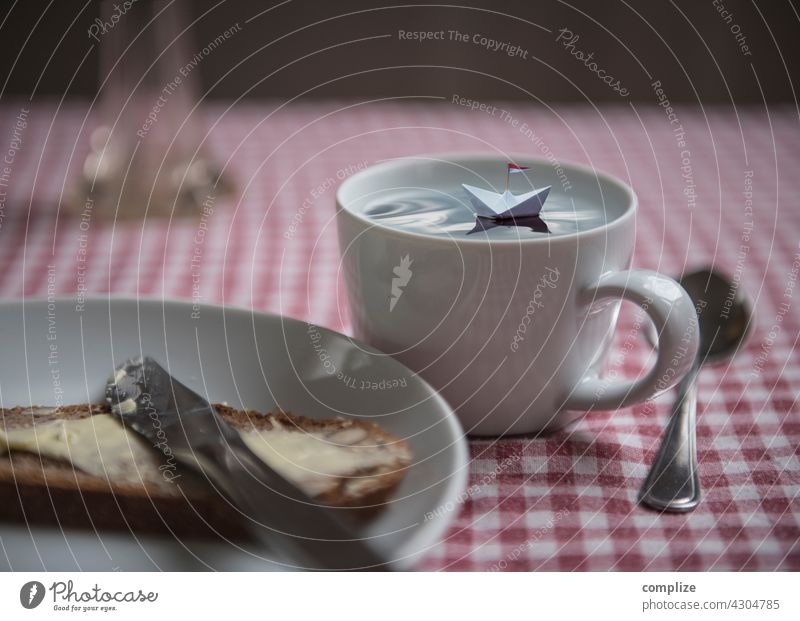 Small paper ship floating in a cup on a breakfast table Gorgeous Dream trip Paper boat Freedom Miniature Breakfast Plate Handicraft travel voyage vacation
