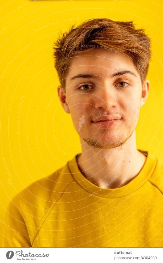 Portrait of a young man against yellow background Man youthful teenager Boy (child) masculine Yellow portrait Face Facial hair good-looking Attractive Outdoors