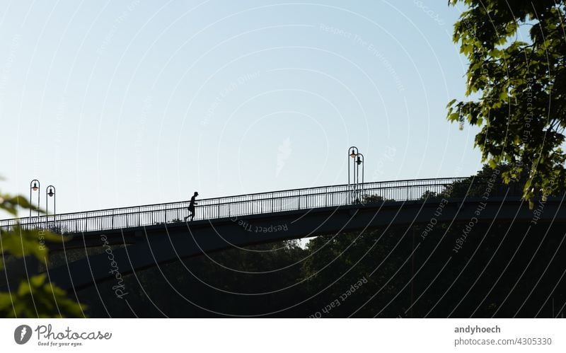 Silhouette of a joggers on a bridge action active activity adult athlete athletes athletic athletics Background backlit competition copy space endurance energy